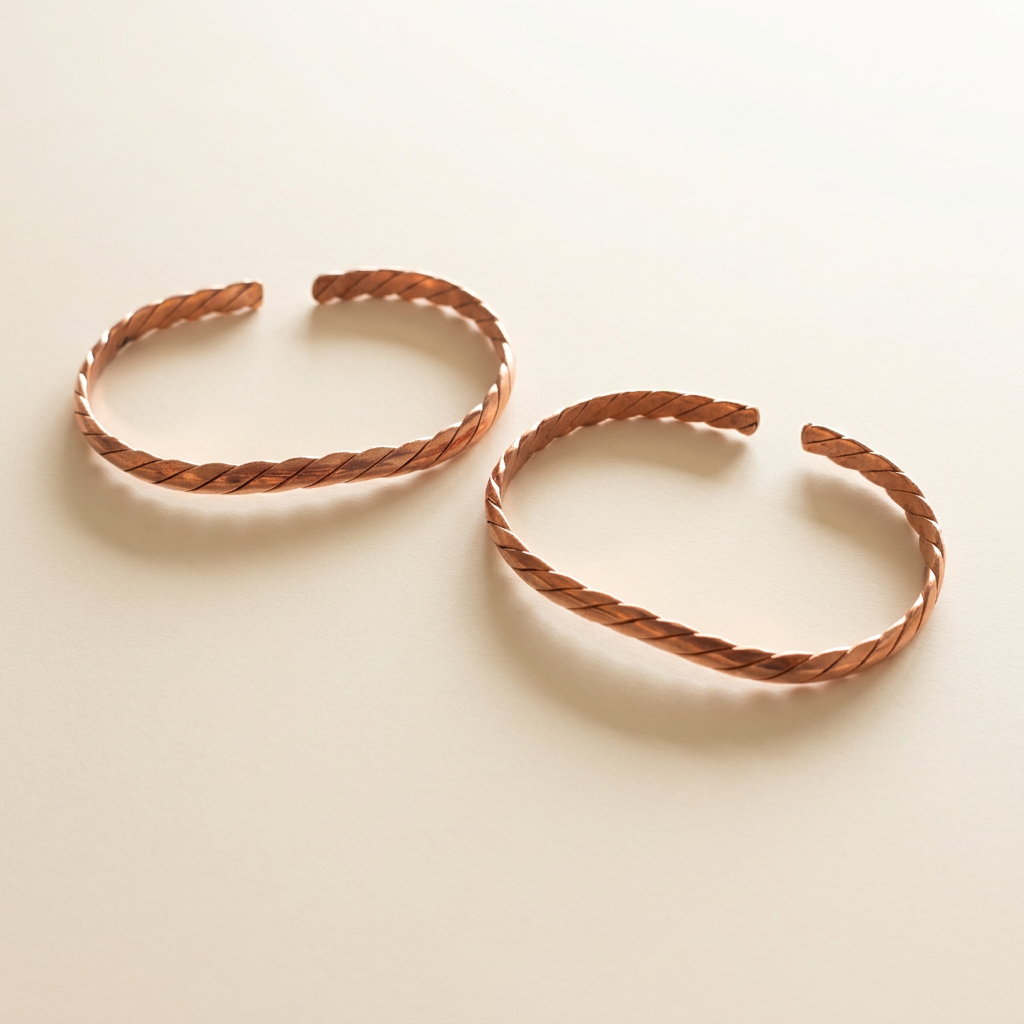 Pulseras de cobre trenzado sobre fondo marfil suave